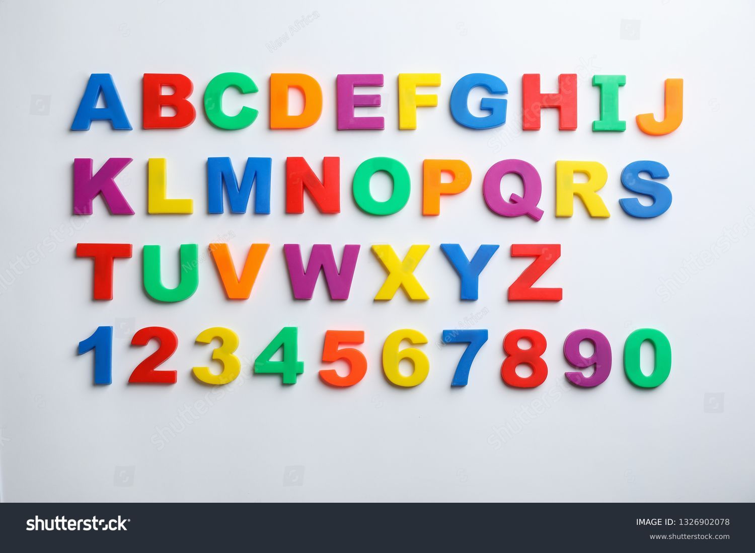 Plastic magnetic letters and numbers isolated on white, top view #1326902078