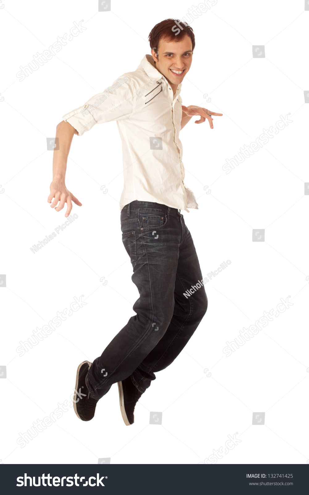 Casual young man jumping. Studio shot over white. #132741425
