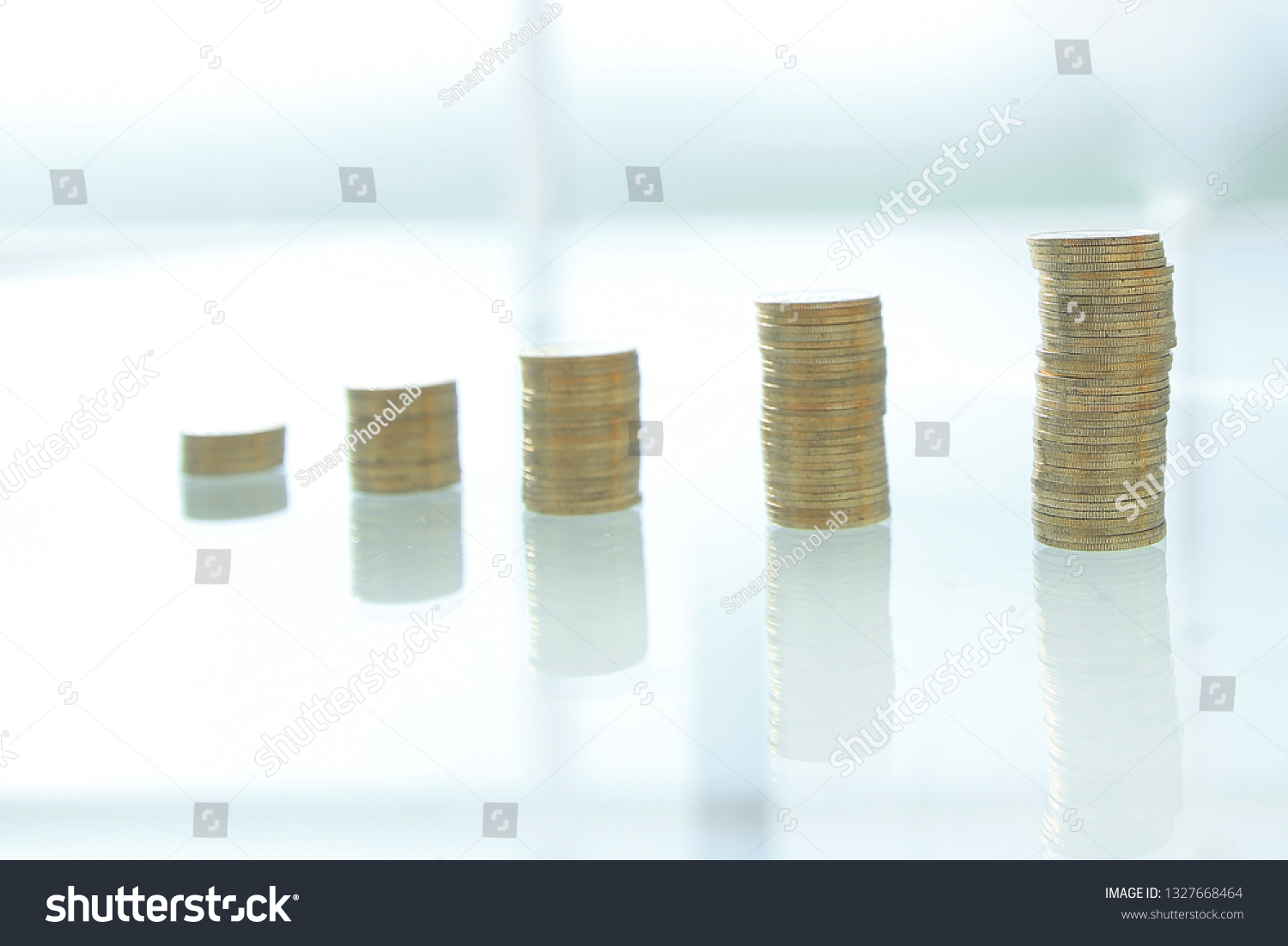 close up. businessman stacking coins in stacks on a glass table #1327668464