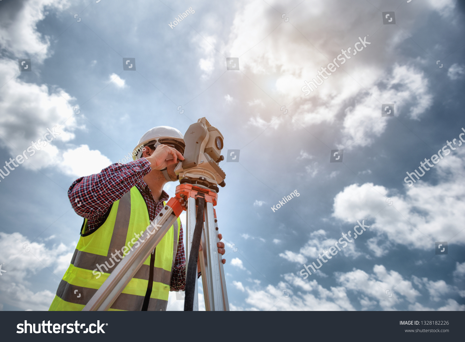 Surveyor equipment. Surveyor’s telescope at construction site or Surveying for making contour plans are a graphical representation of the lay of the land before startup construction work  #1328182226