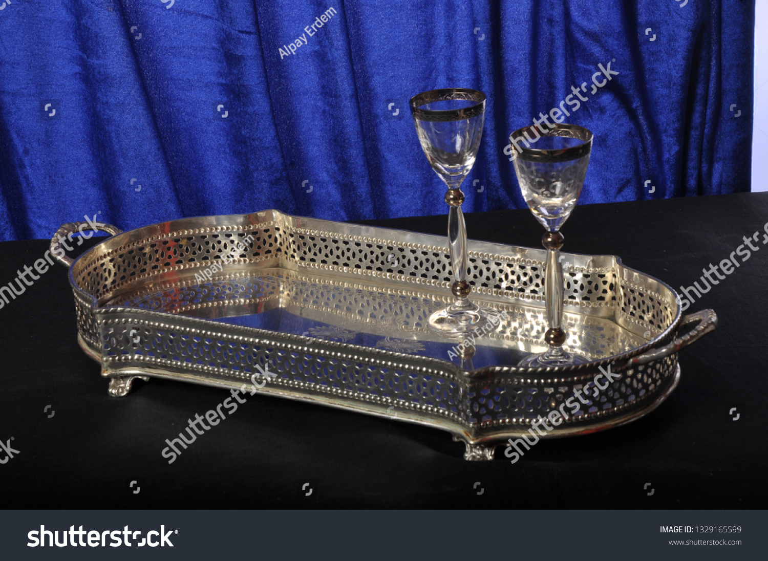 Silver salver on a blue background with 2 wine glasses #1329165599