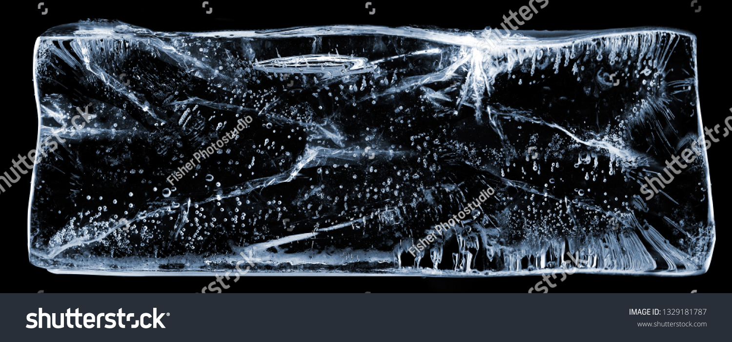 Large rectangle of clear ice with bubbles, on black. Creative concept photo of large rectangle of clear pure cool cold frozen water ice with bubbles on black background. #1329181787