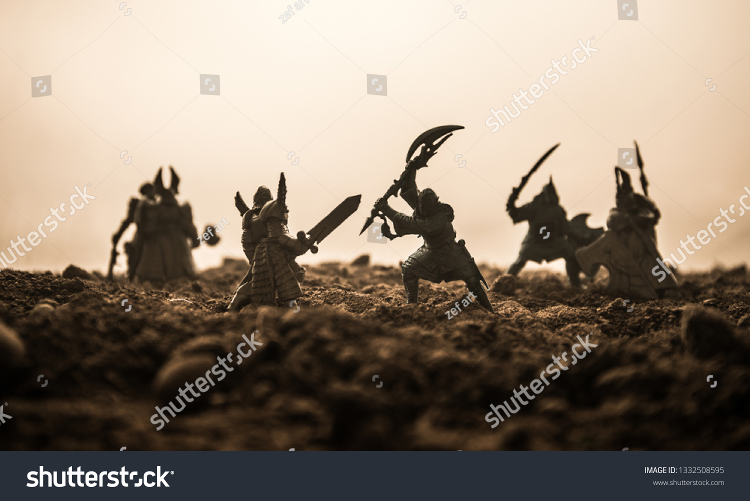 Medieval battle scene with cavalry and infantry. Silhouettes of figures as separate objects, fight between warriors on sunset foggy background. Artwork decoration. Selective focus #1332508595