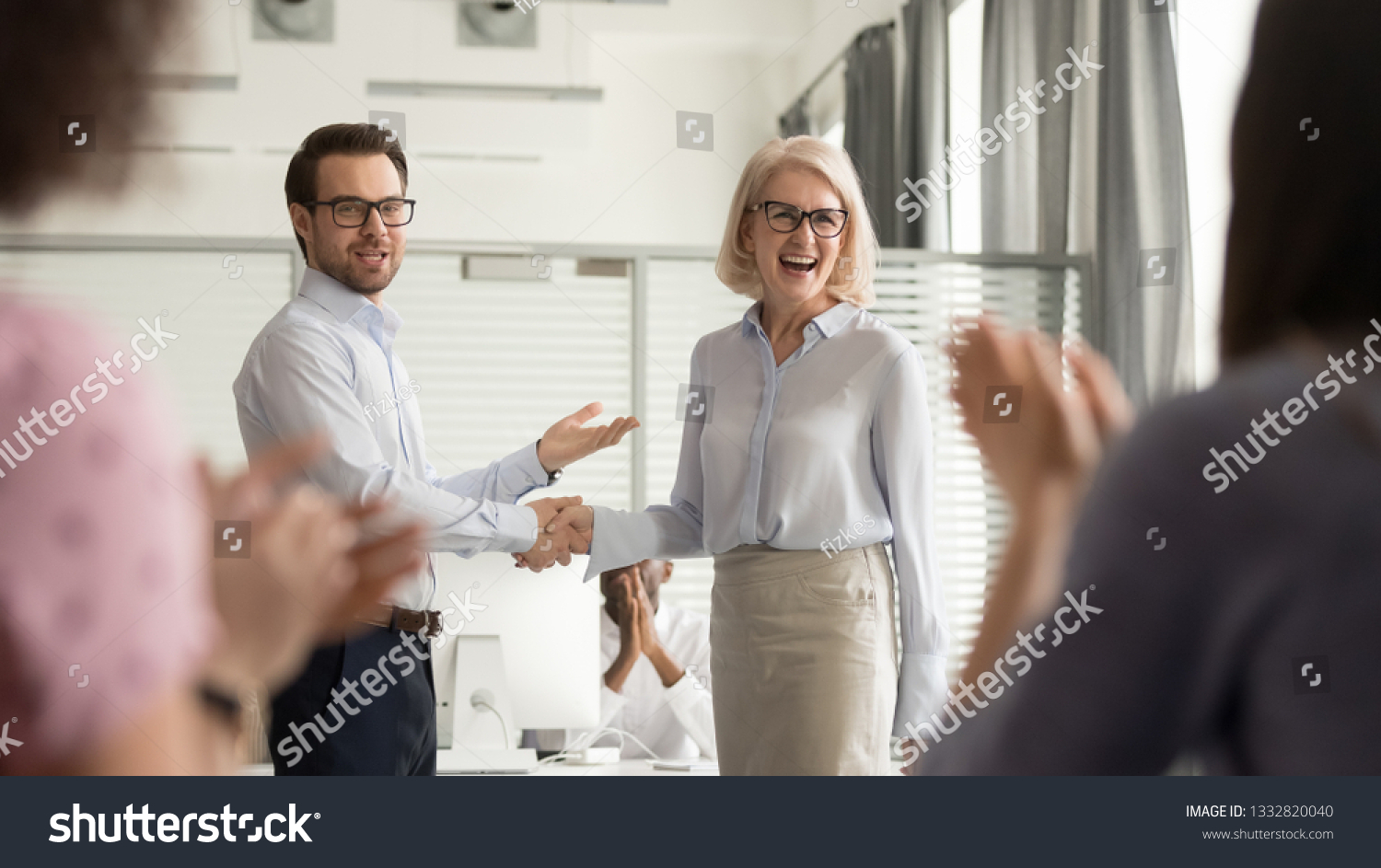 Happy manager boss praising old employee for good work get team appreciation acknowledgement handshaking successful worker congratulating promoting rewarding welcoming new partner, respect handshake #1332820040