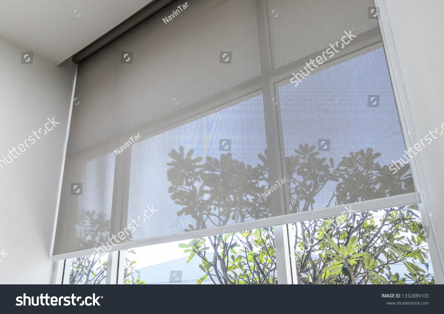 Roll Blinds on the windows, the sun does not penetrate the house. Window in the Interior Roller Blinds. Beautiful Blinds on the Window, the Sun and Heat Protection, the Perfect Windows Interior Decor #1332889100