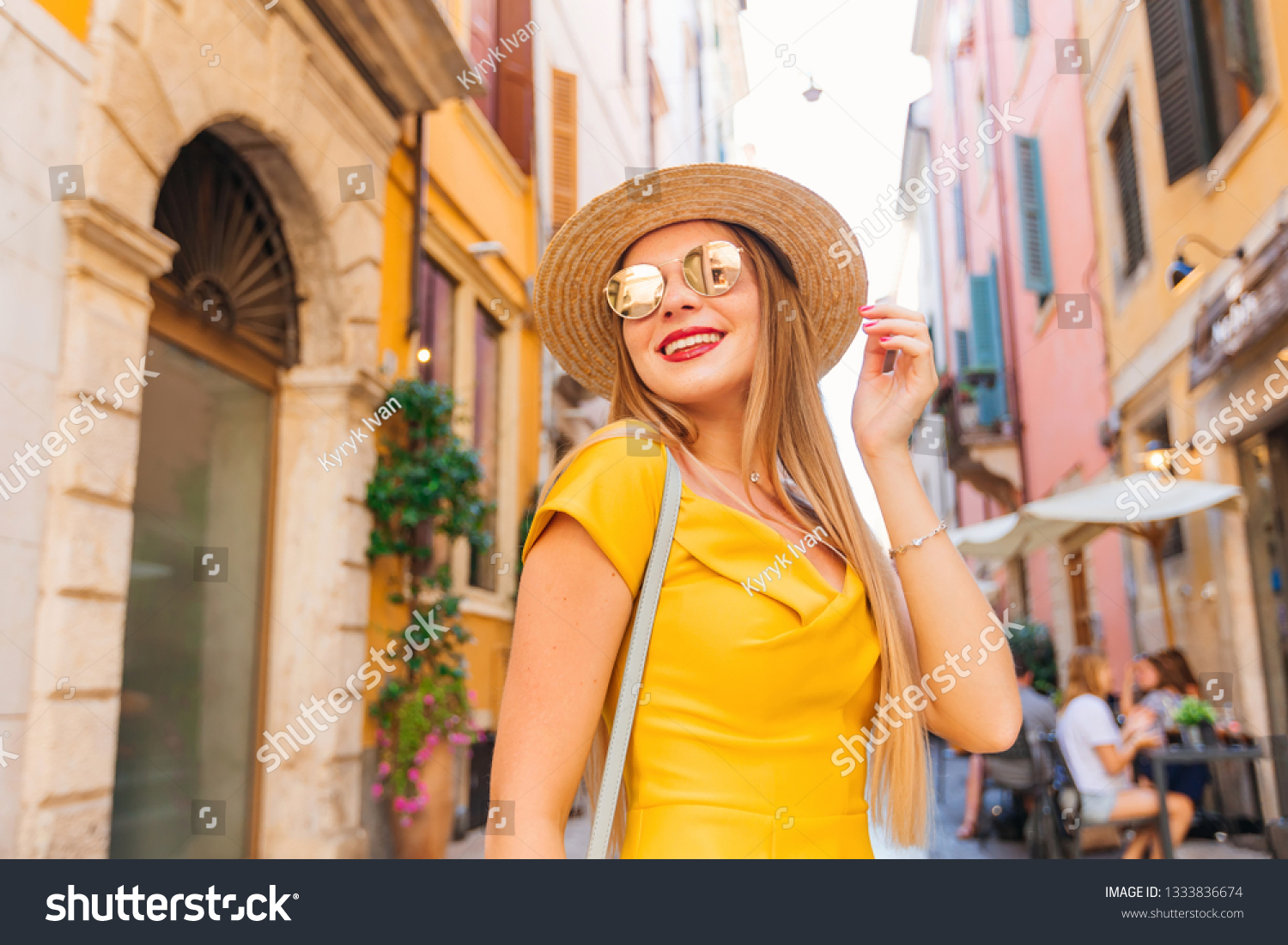 Attractive stylish girl in stylish sunglasses and boater on the street of the city #1333836674