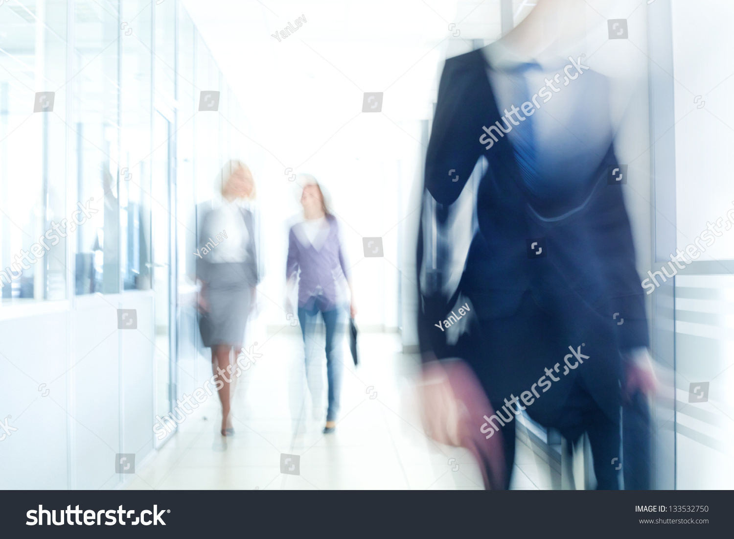 businesspeople walking in the corridor of an business center, pronounced motion blur #133532750