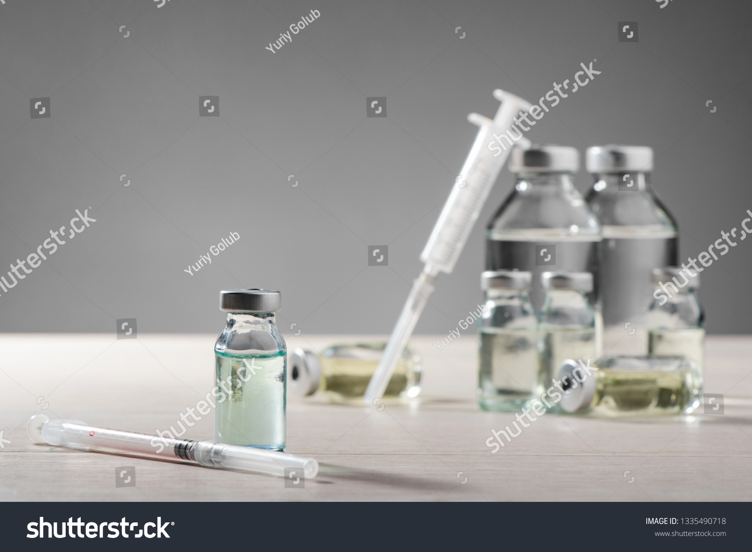Vials and syringes on white table. Innovative medicines, important drugs for injections. #1335490718
