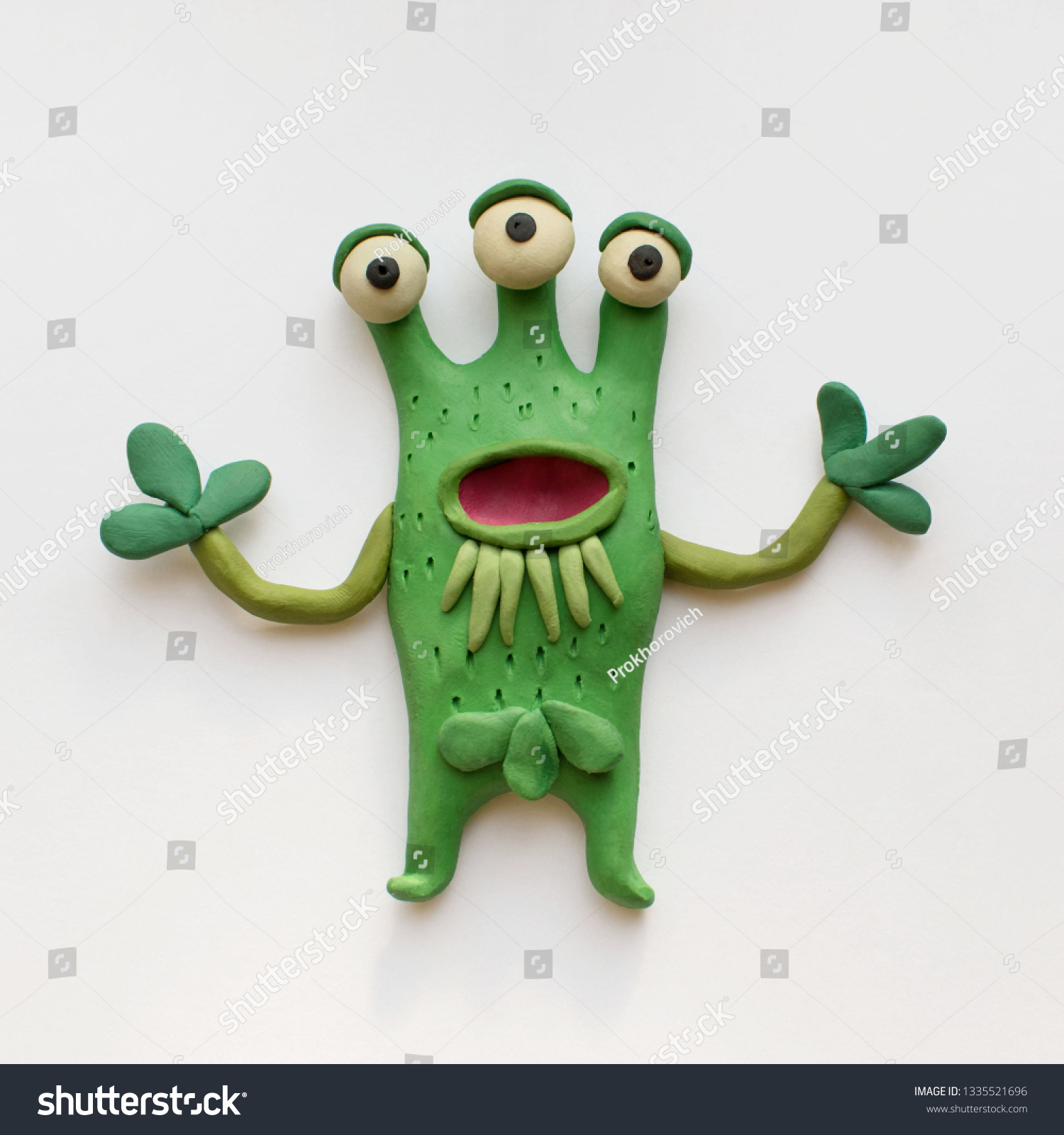 Funny three-eyed monster plant. Plasticine character on a white background #1335521696