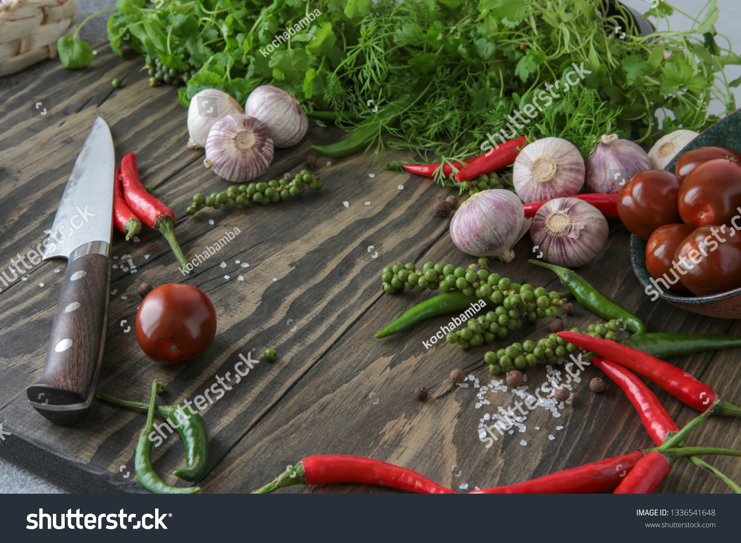 chili, allspice, garlic, parsley, coriander, dill, tomatoes on the table #1336541648