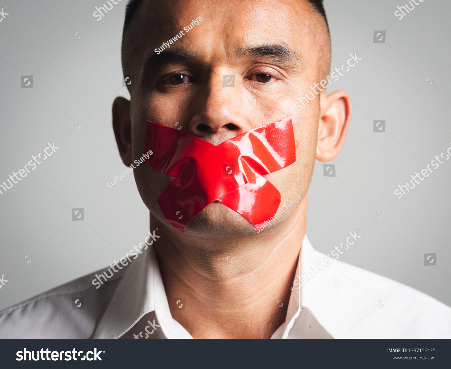 Man is silenced with adhesive red tape across his mouth sealed to prevent him from speaking. Freedom Concept. #1337156435