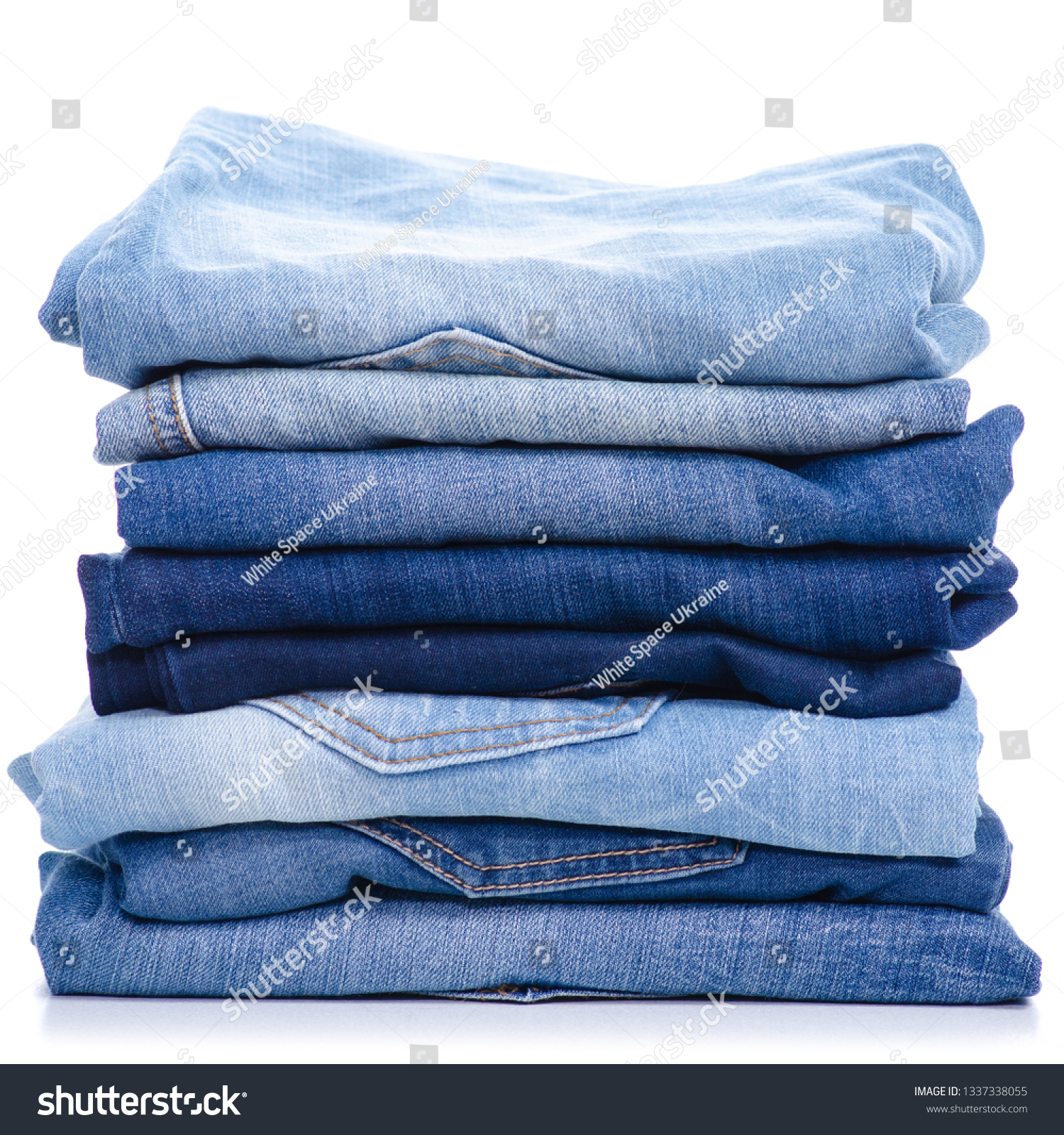 Stack blue jeans on white background isolation #1337338055