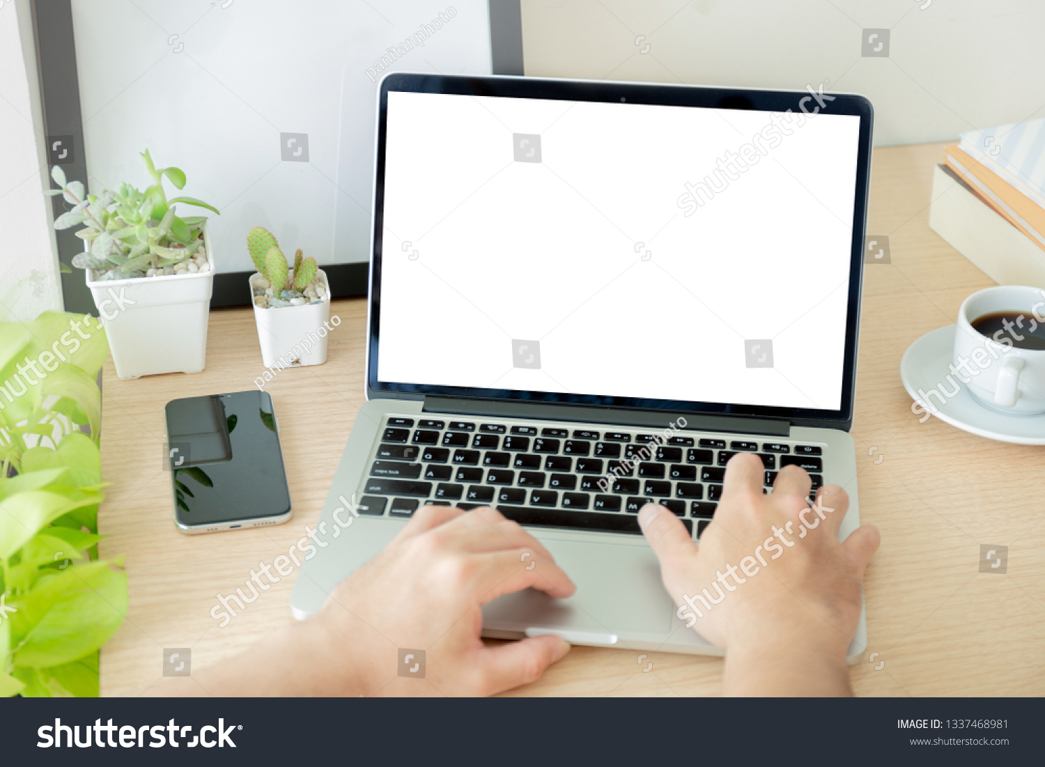 mockup image computer hand typing with blank screen for text,man using laptop contact business and searching information in workplace on desk in office.design creative work space on wooden desktop #1337468981