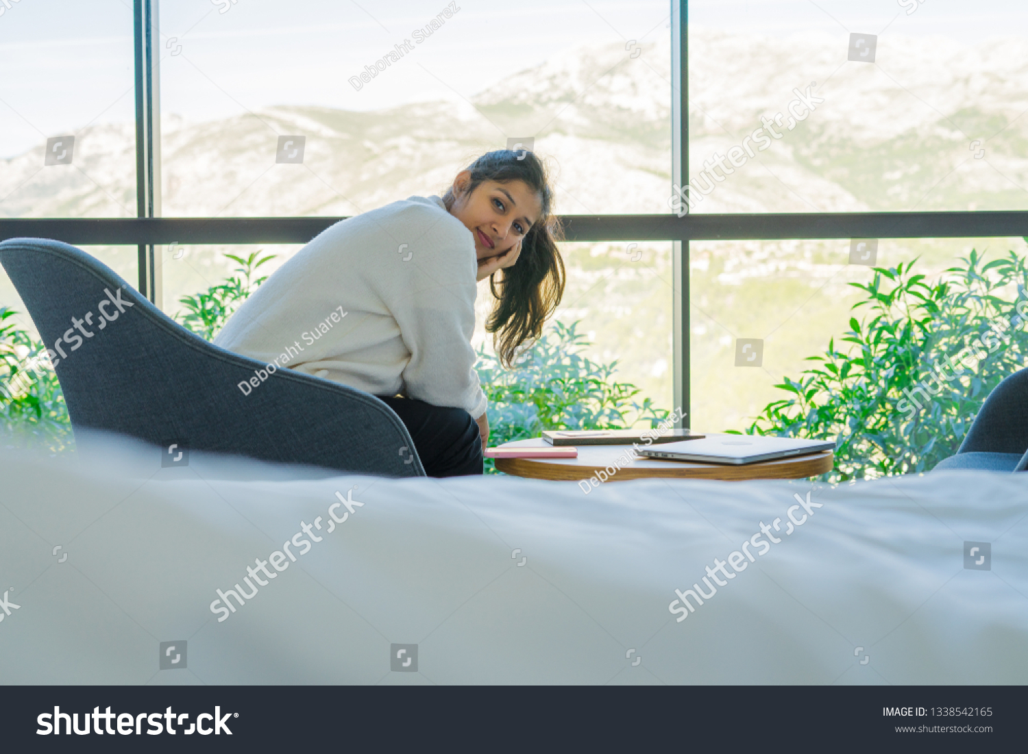 young woman sitting in the bedroom #1338542165