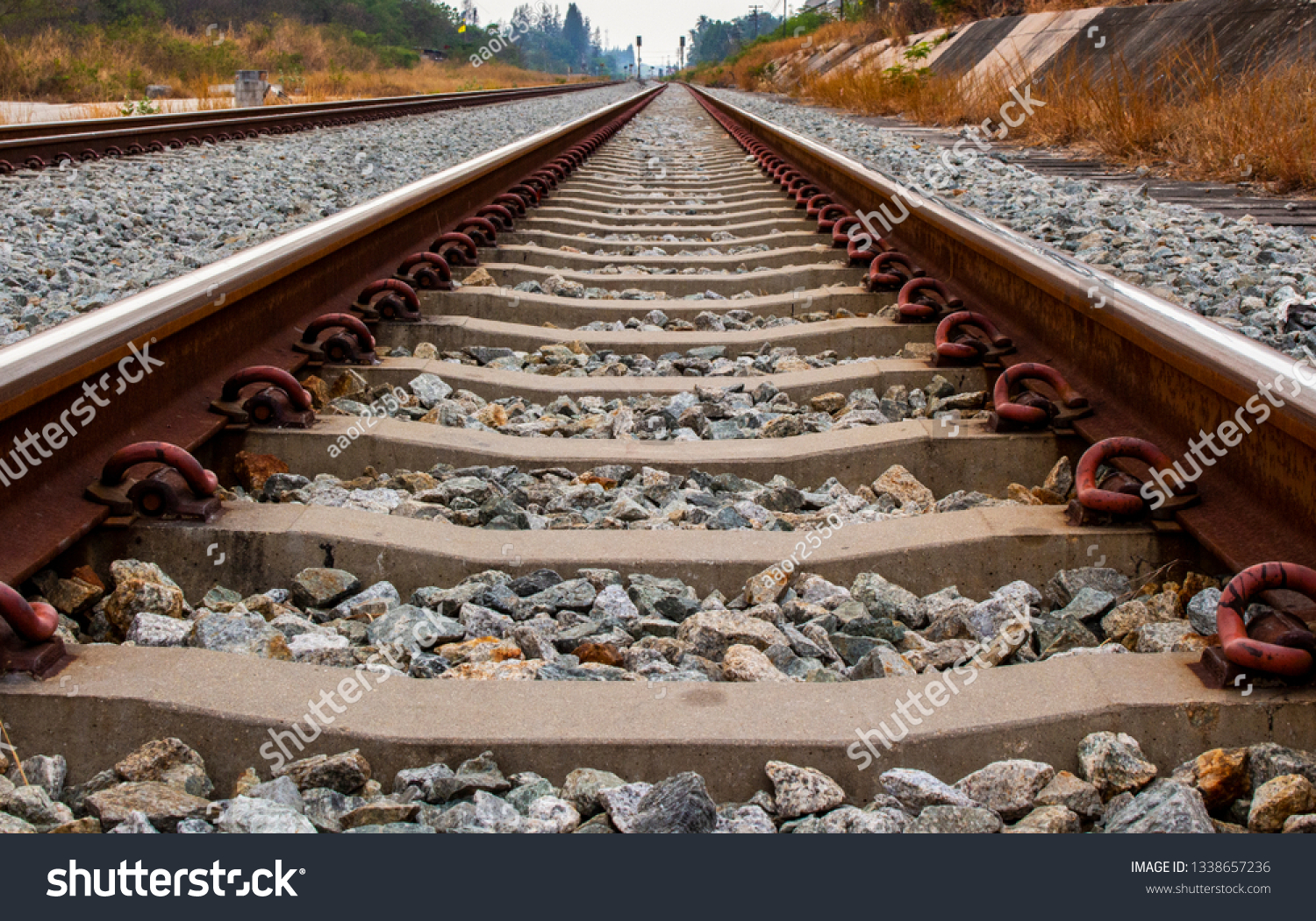 Close up of iron railroad and concrete railroad sleeper or railroad tie. #1338657236