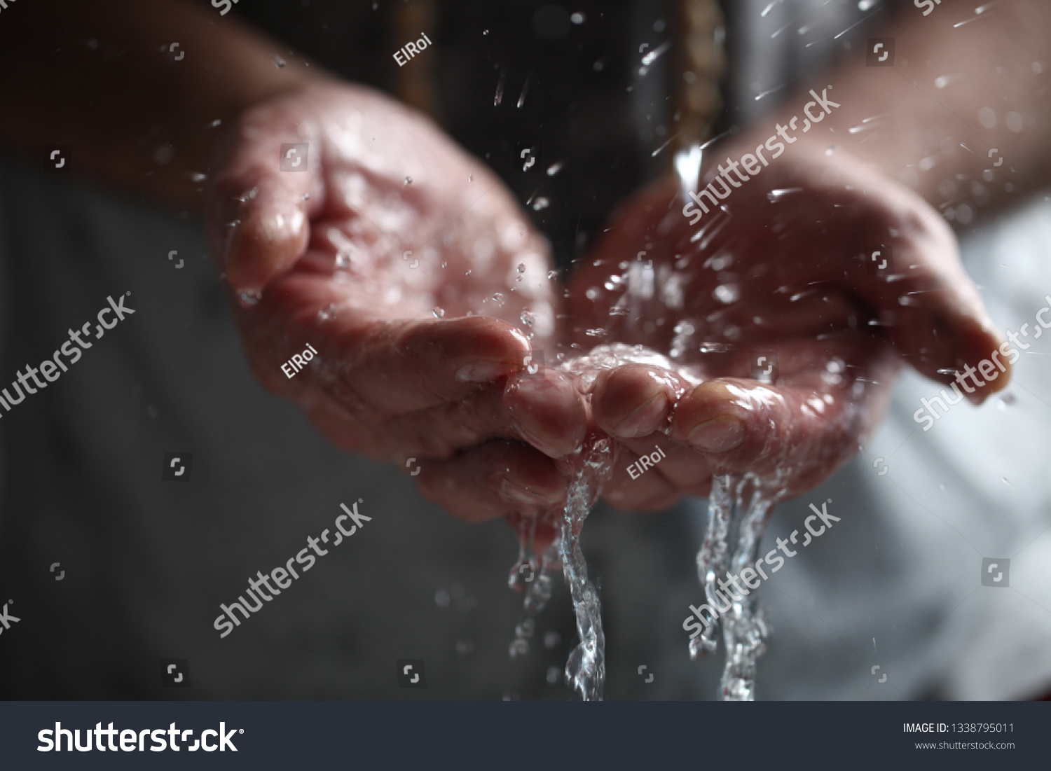 Muslim man washes his hands before prayer ritual cleansing. #1338795011