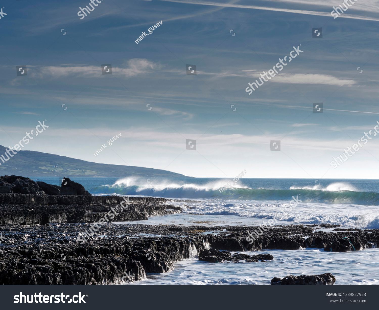 West coast of Ireland, Ocean's wave and blue cloudy sky. West coast of Ireland, county Clare. #1339827923