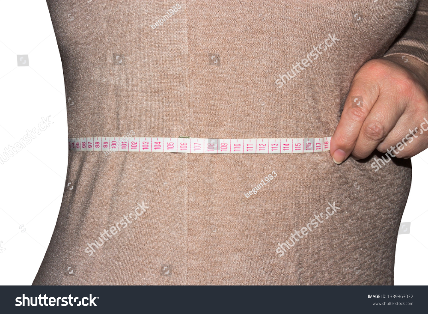 Woman measures waist size.The waist of a woman on a white background. #1339863032