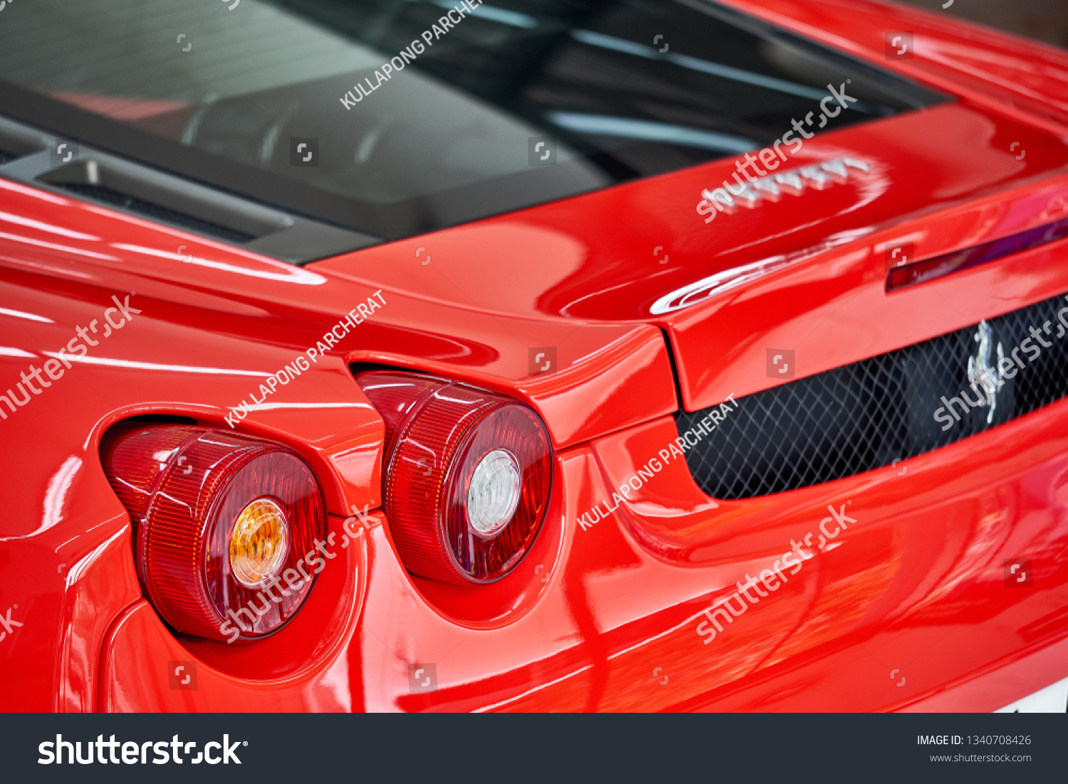 BANGKOK, THAILAND - FEBRUARY 21, 2019: Shiny red Ferrari F430 supercar taillight with reflection on paint. Luxury sports car after ceramic coat. Car detailing & garage concept. Automotive background. #1340708426