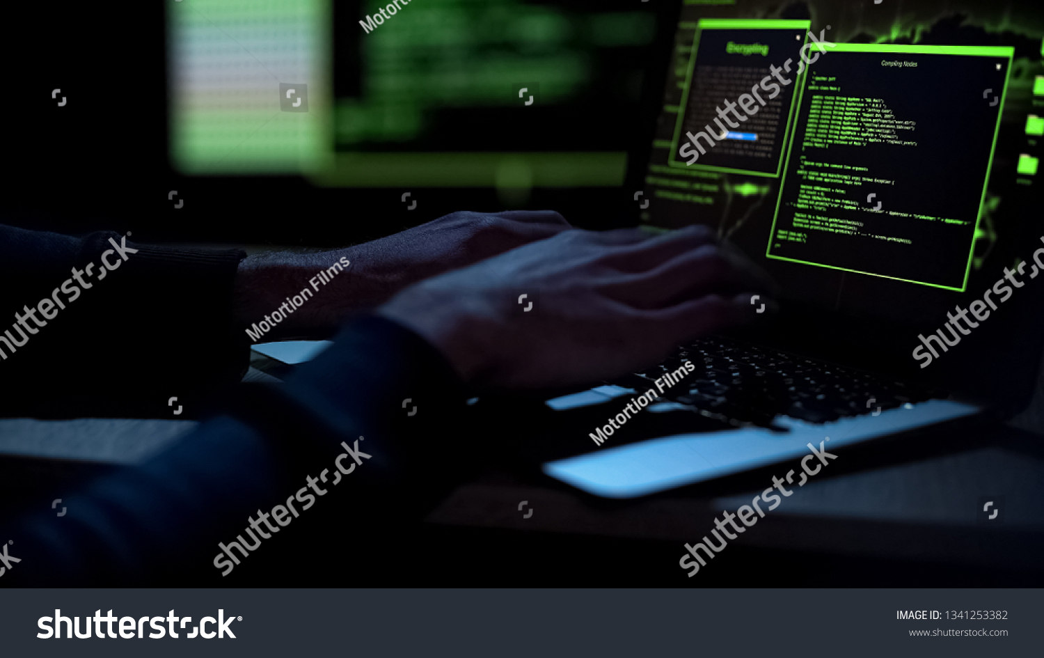 Cybercriminal creating malicious software, typing on laptop keypad, closeup #1341253382