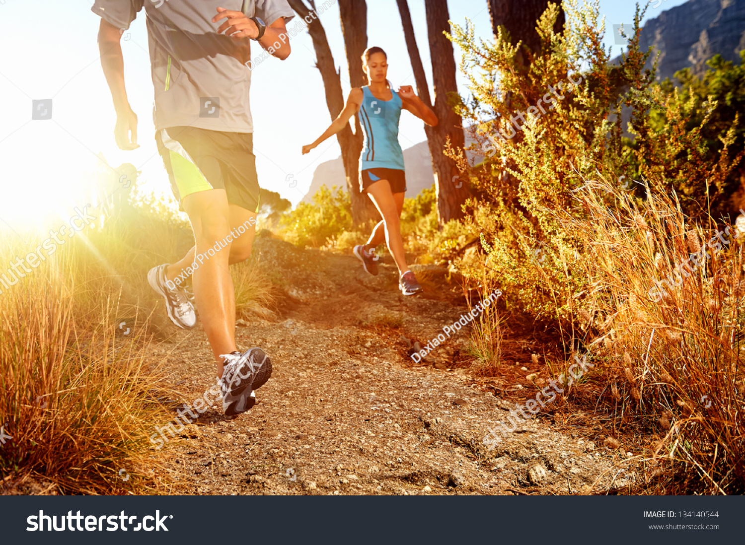 Trail running marathon athlete outdoors sunrise couple training for fitness and healthy lifestyle #134140544