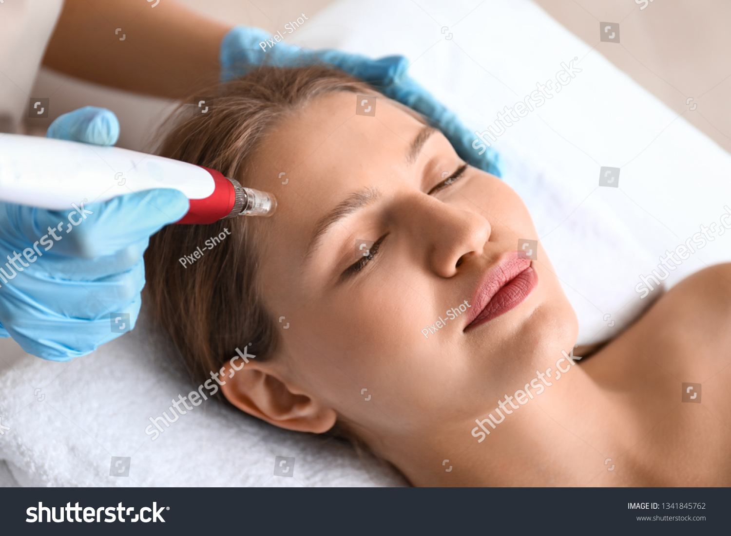 Young woman undergoing procedure of bb glow treatment in beauty salon