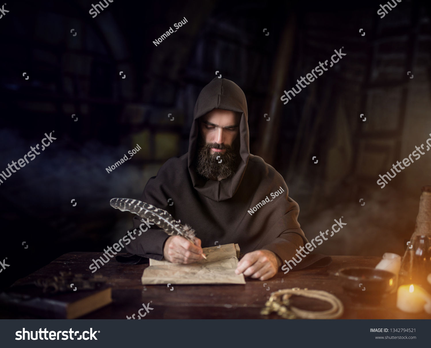 Medieval monk in robe writes with a goose feather #1342794521