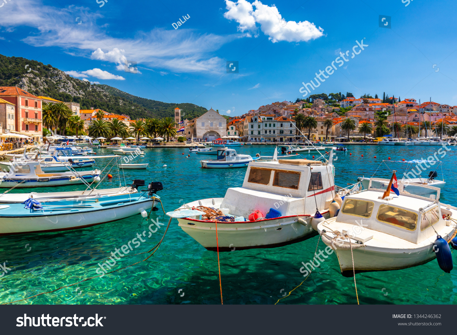 View at amazing archipelago with boats in front of town Hvar, Croatia. Harbor of old Adriatic island town Hvar. Popular touristic destination of Croatia. Amazing Hvar city on Hvar island, Croatia.  #1344246362