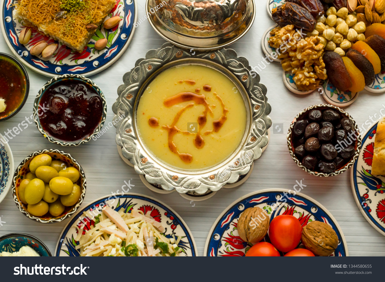 Traditional Turkish Ramadan,iftar meal table with lentil soup in vintage silver soup bowl on middle of table with other foods. #1344580655