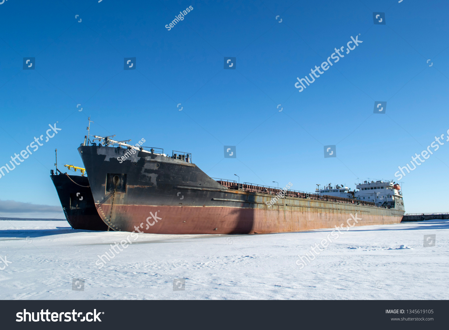 Cargo vessels at the port in the winter parking #1345619105