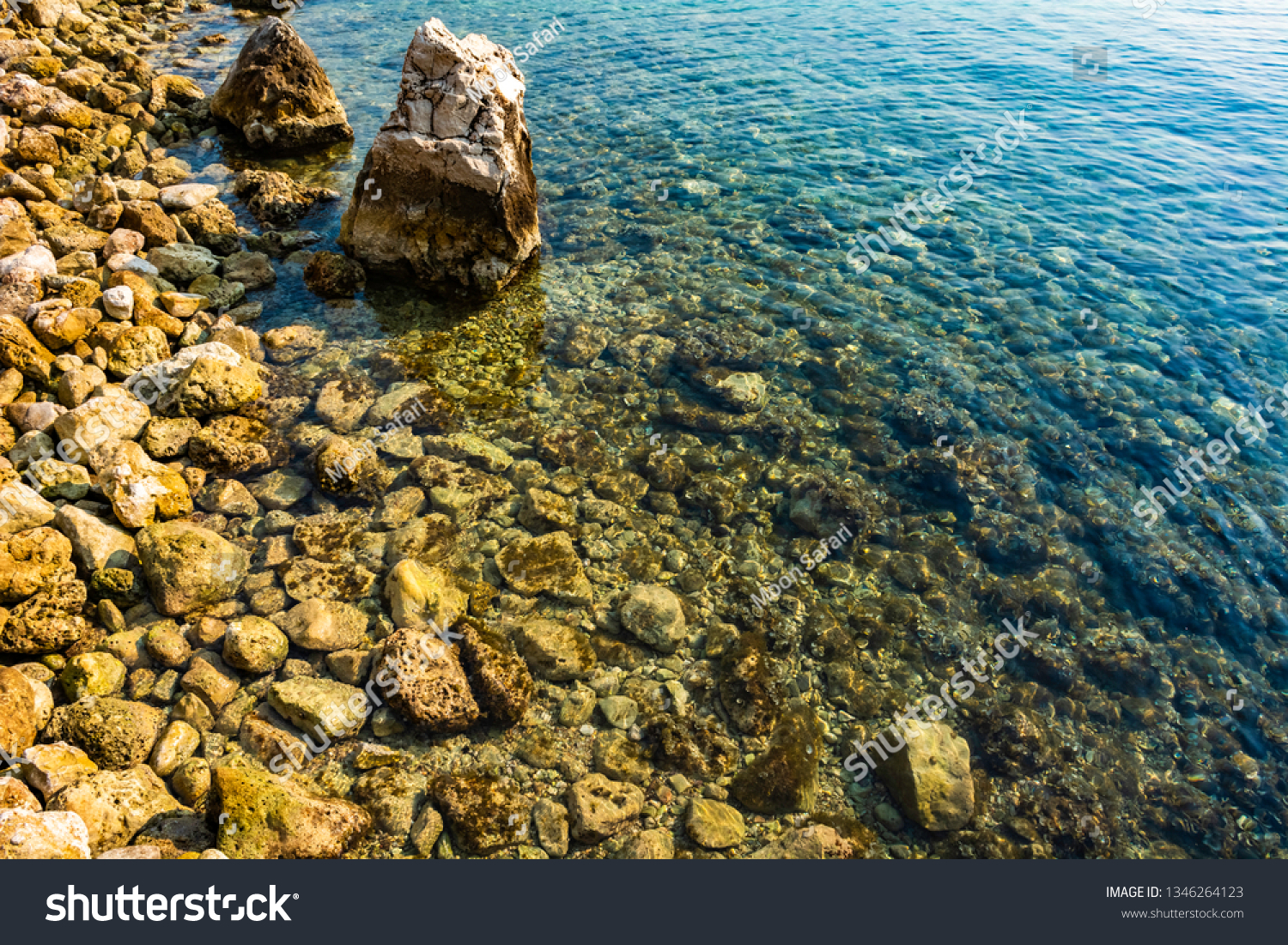 Rocks in sea ocean shallow water calm - Sea ocean rock waterline underwater - Calm sea ocean rock under golden sun wild coast #1346264123