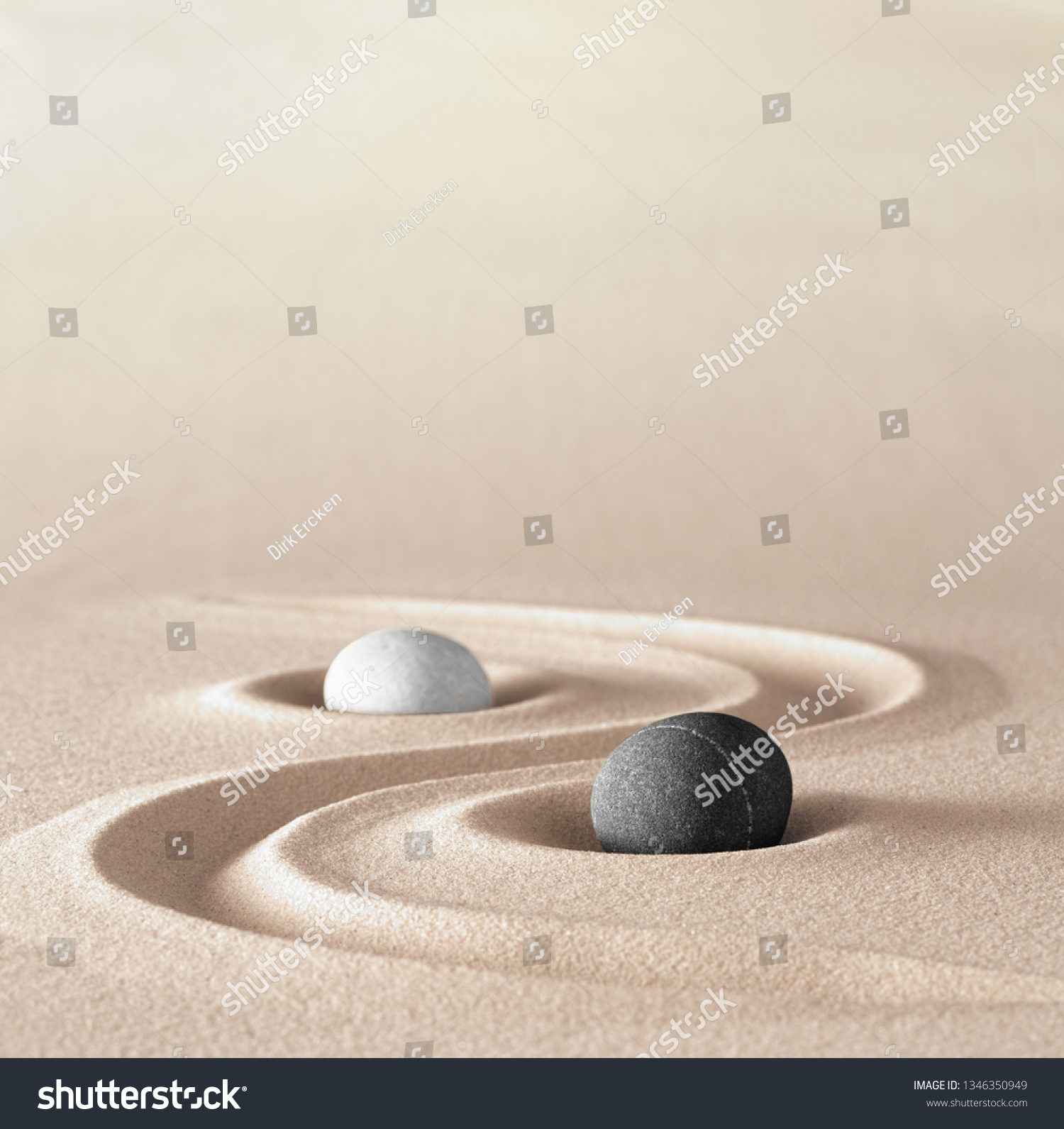 yin and Yang symbol of dualism in ancient Chinese philosophy where opposite or contrary forces are complementary. Like light and dark or fire and water, male and female. A black an white round stone #1346350949