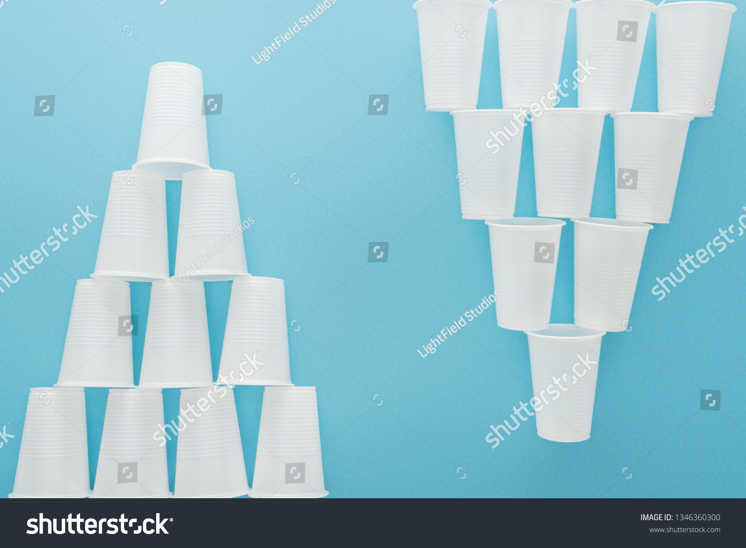 flat lay with white plastic cups isolated on blue with copy space #1346360300