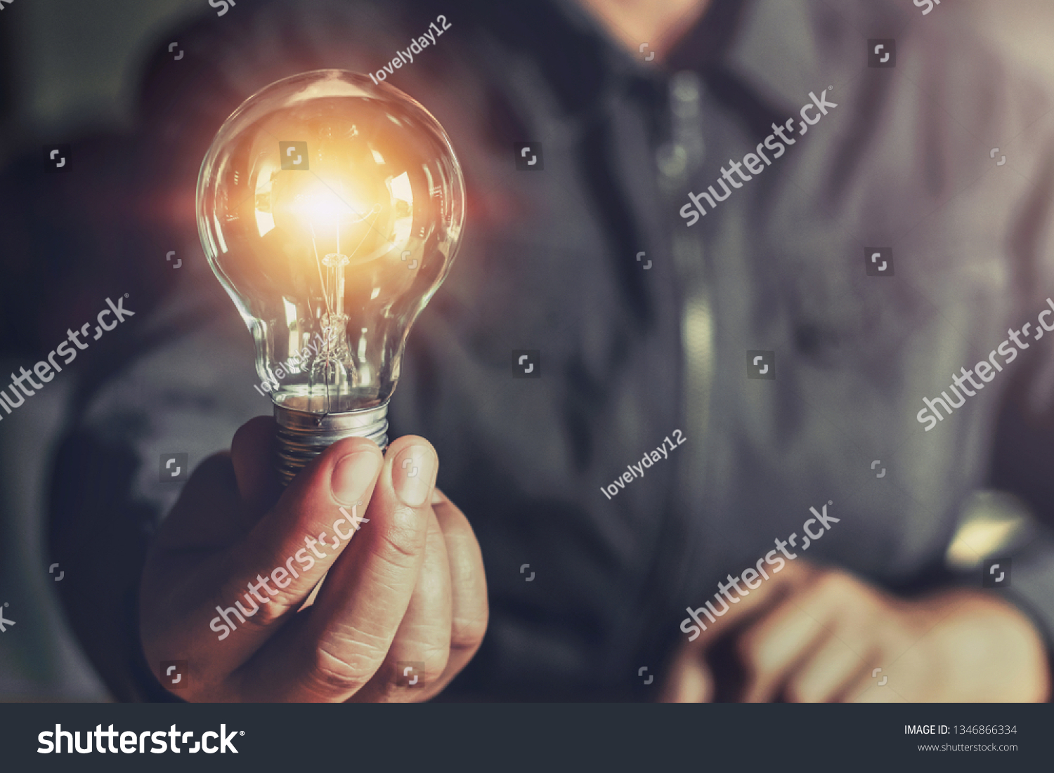  hand holding light bulb. idea concept with innovation and inspiration #1346866334