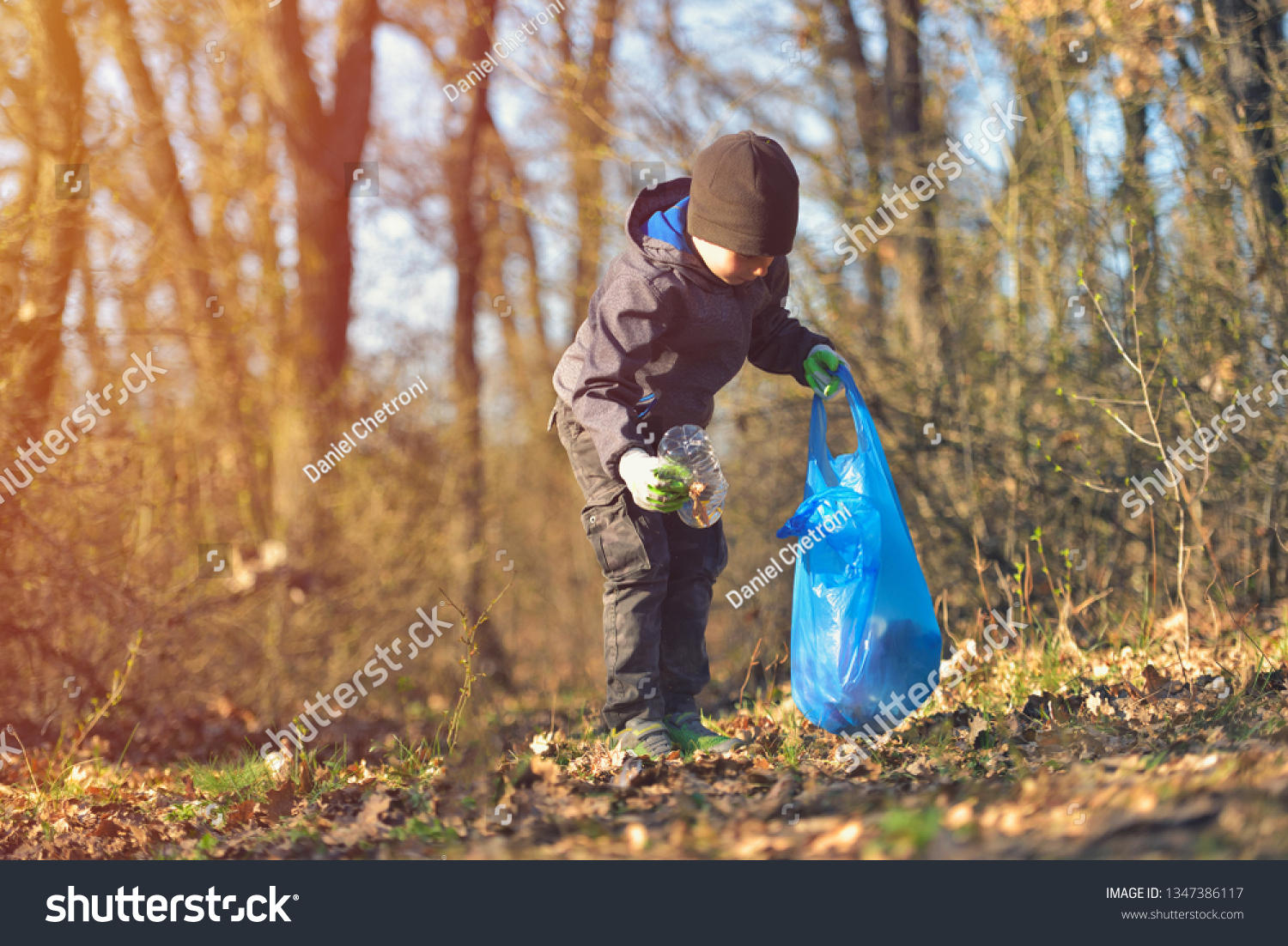 Recycle waste litter rubbish garbage trash junk clean training. Nature cleaning, volunteer ecology green concept. Young men and boys pick up spring forest at sunset. Environment plastic pollution #1347386117