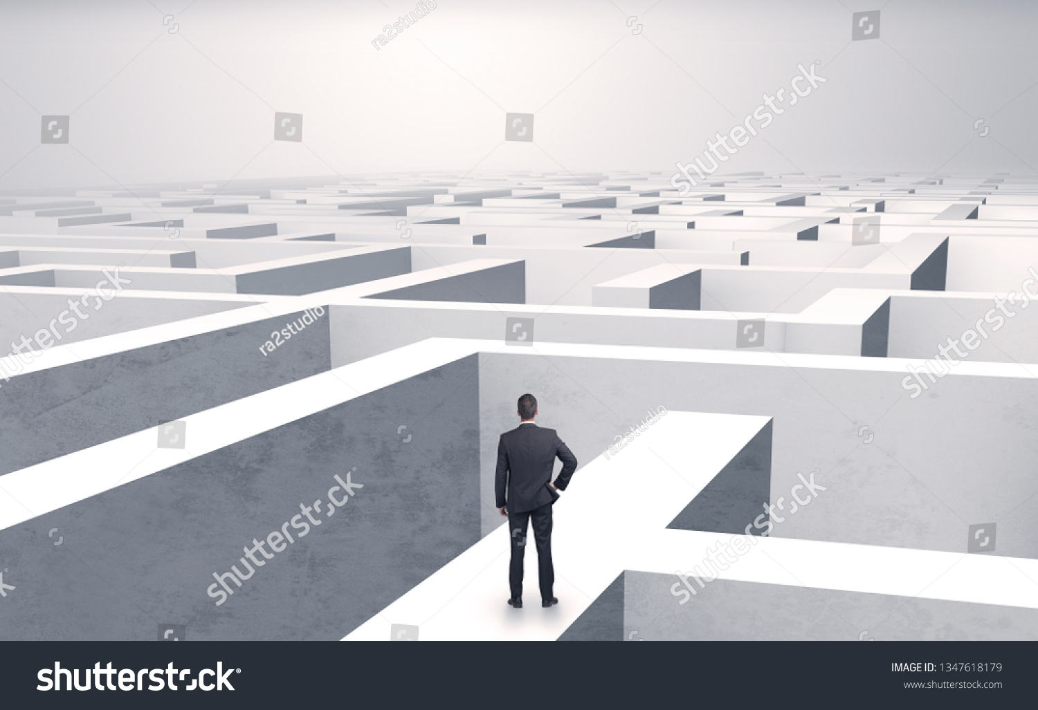 Small businessman in a middle of a huge maze #1347618179