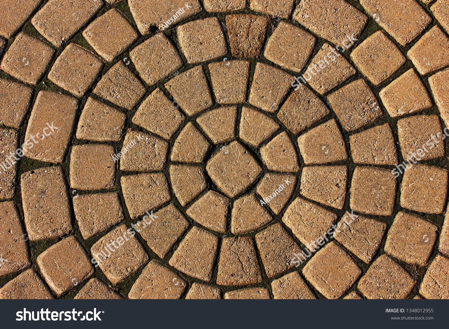 Stone pavement in perspective. Stone pavement texture. Granite cobblestoned pavement background. Abstract background of a cobblestone pavement close-up #1348012955