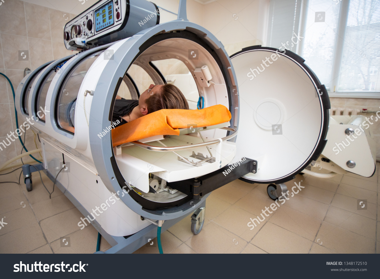young guy in a hyperbaric chamber, oxygen treatment, medical chamber #1348172510