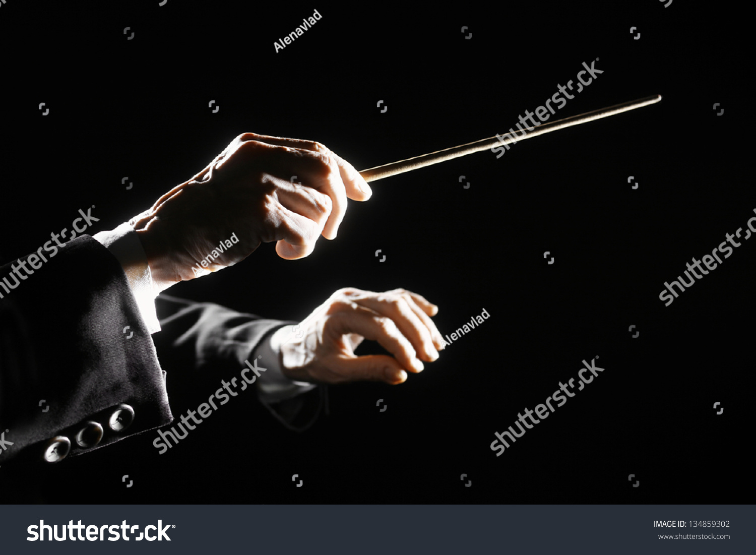 Orchestra conductor hands baton. Music director holding stick #134859302