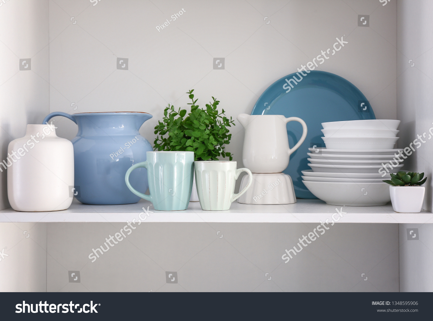 Shelf with clean dishes in kitchen #1348595906