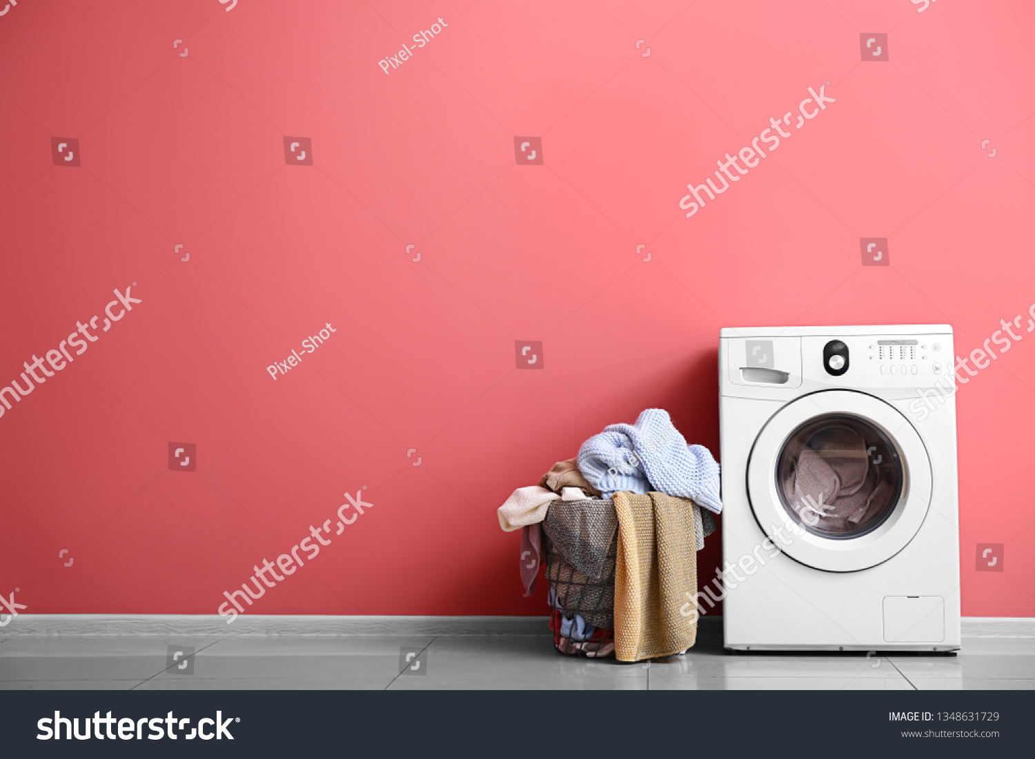 Modern washing machine and laundry near color wall #1348631729