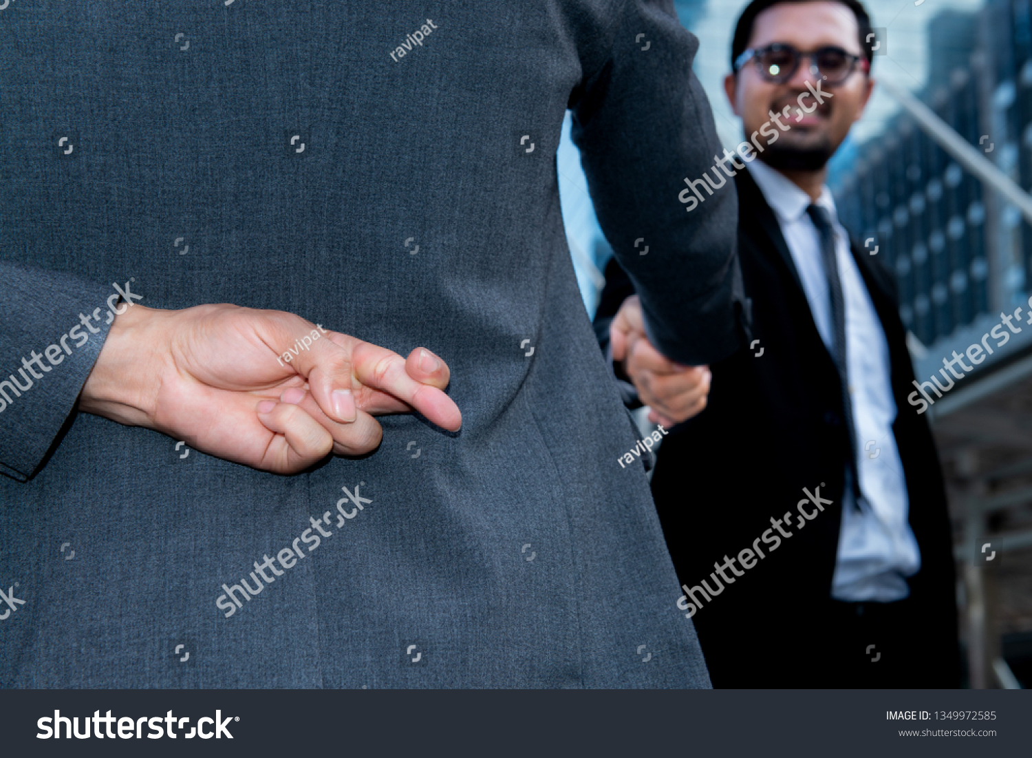 Politician shake hands together and holding another fingers crossed behind his back,Honesty isn't always,Here's when it might be better to lie,Dishonest businessman telling lies,Trickery Concept  #1349972585