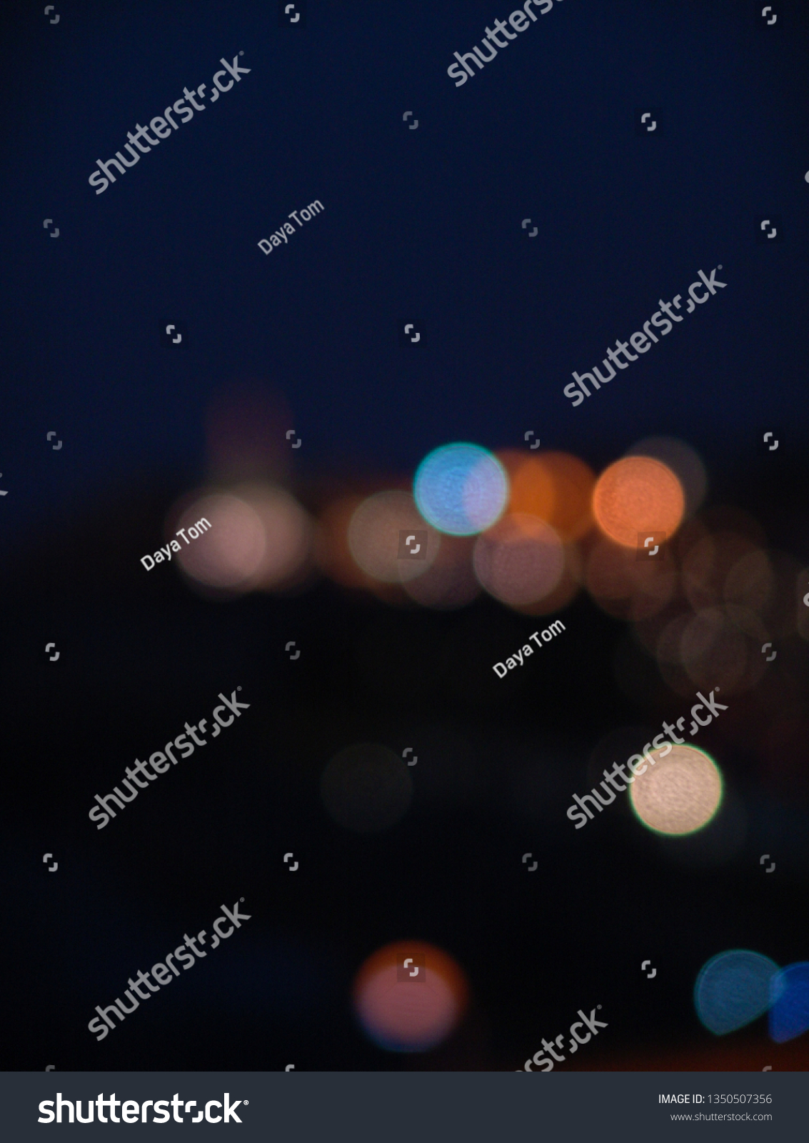 Night city lights bokeh of defocused vivid colorful circles of light in blue hour background in Jaffa, Israel #1350507356