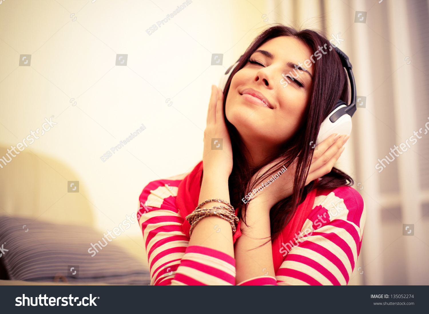Young beautiful woman in bright outfit enjoying the music at home #135052274