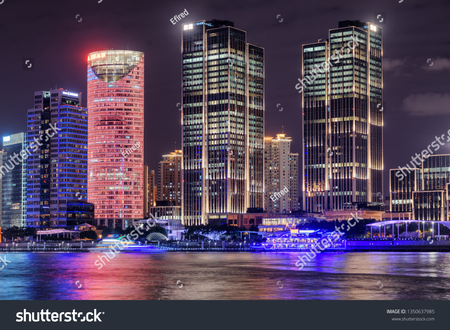 Amazing night view of modern waterfront buildings at the Pudong New Area (Lujiazui) in downtown of Shanghai, China. Colorful city lights reflected in water of the Huangpu River. #1350637985