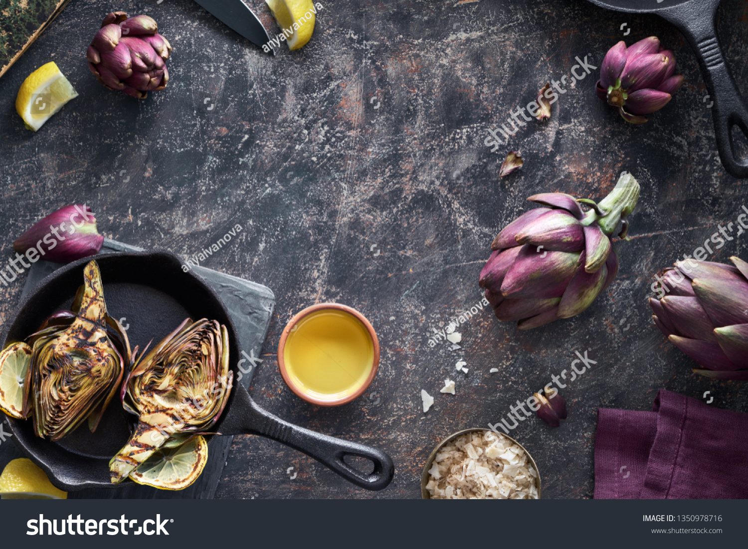 Flat lay with fresh and grilled red artishokes, whole and halved, on dark textured background with copy-space #1350978716