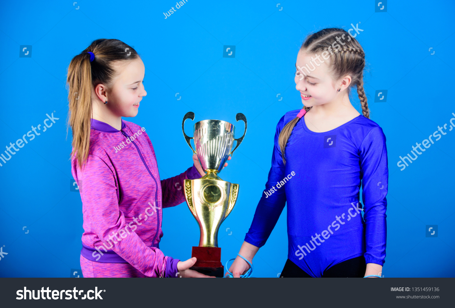 Winners in competition. victory of teen girls. Sport success. Acrobatics and gymnastics. Little girls hold jump rope. Happy children with gold champion cup. in the big league. league champions. #1351459136