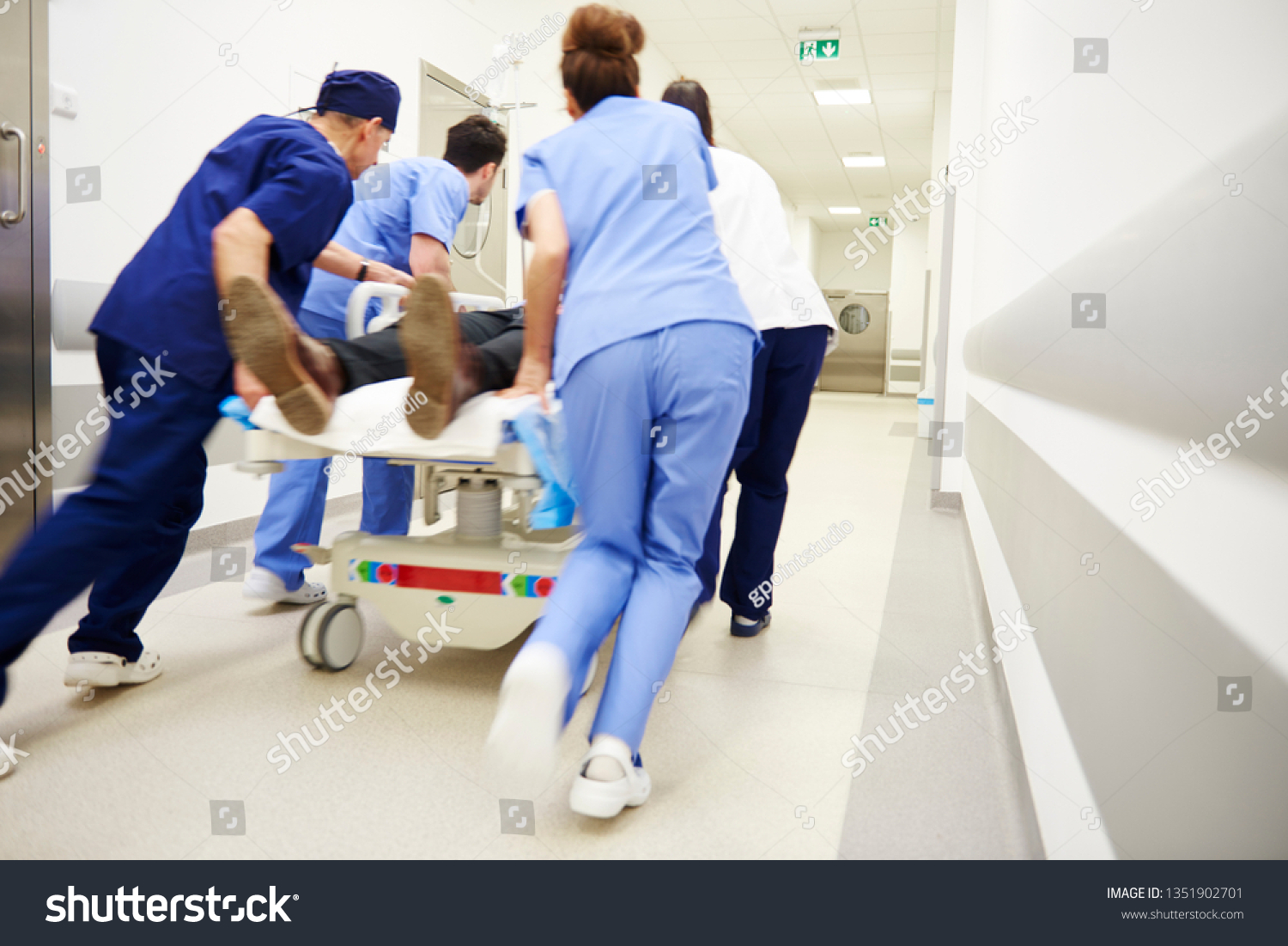 Rear view of doctors running for the surgery  #1351902701