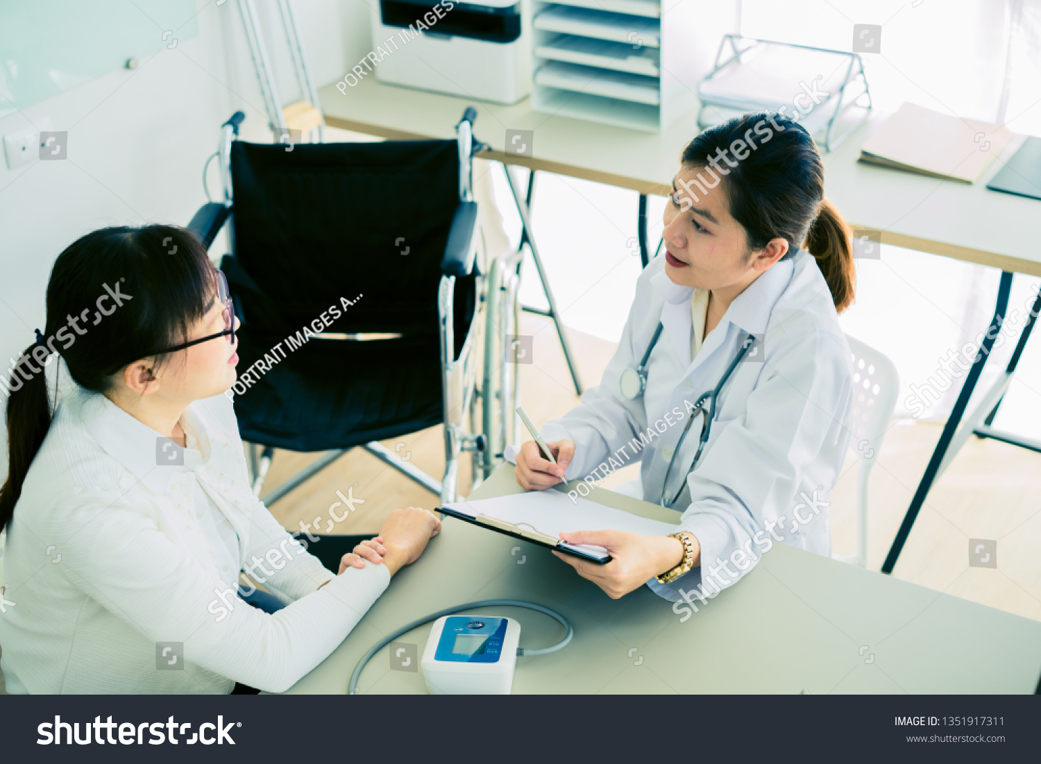 Female doctor consulting patient. Asian people #1351917311