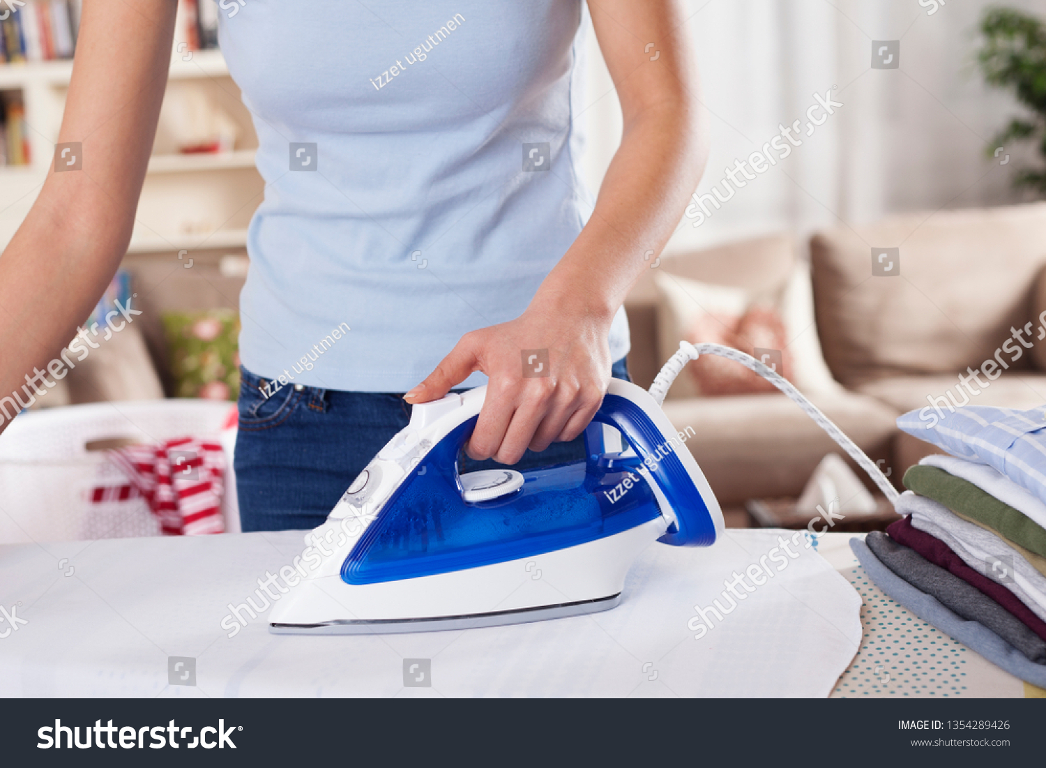 woman ironing clothes at home  #1354289426